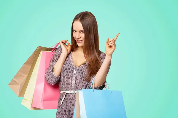 Happy Beautiful Woman Shopping Bags Pointing Copy Space Isolated Green — ストック写真
