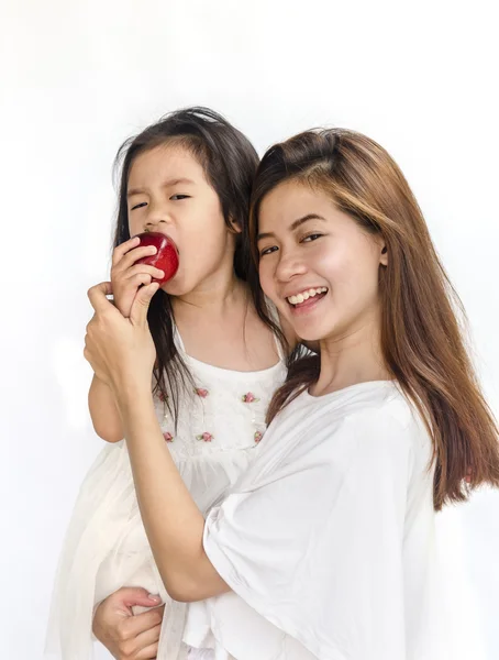 Asian daughter and mom eating red apple. — Stock Photo, Image