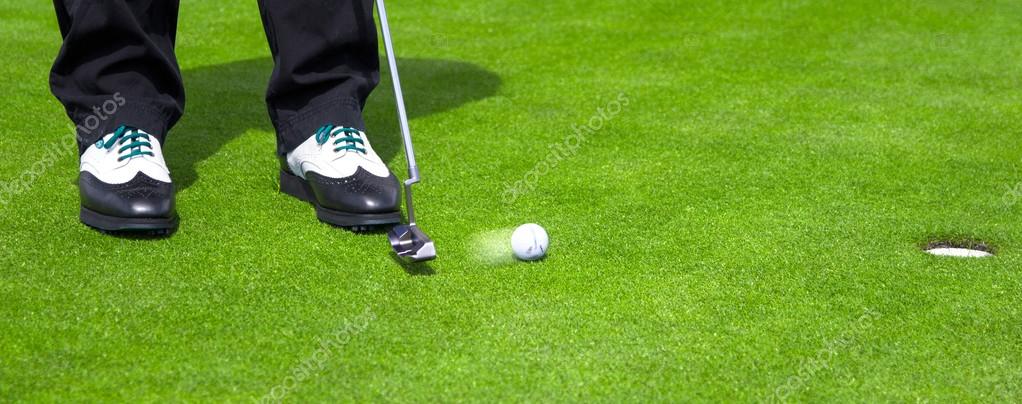 Golf green hole course man putting ball inside short putt Stock Photo