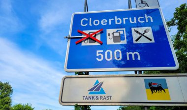 NEUSS, Germany, May 22, 2022: Sign of a highway gas station where fuel is sold out and only electric charging is available clipart