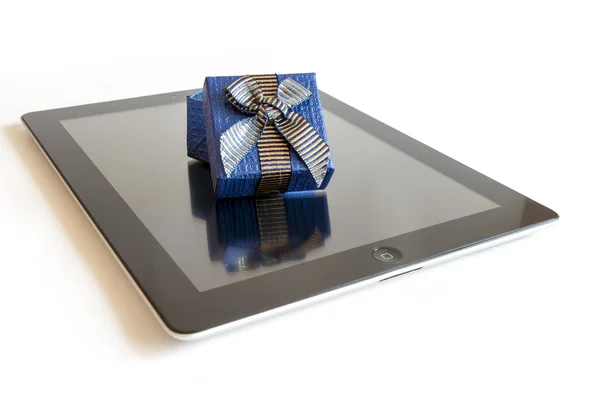 Digital tablet with christmas present — Stock Photo, Image