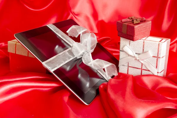 Digital tablet with christmas present — Stock Photo, Image