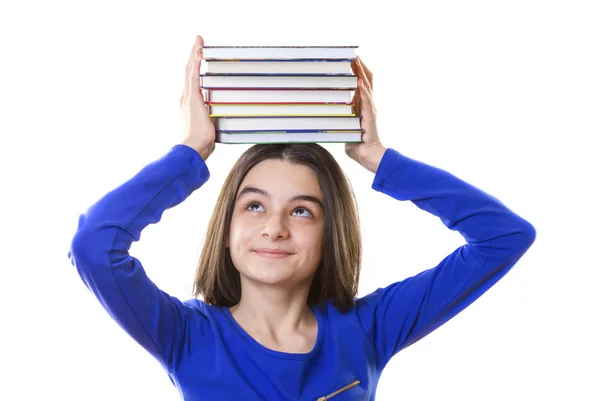 Junges Mädchen mit einem Stapel Bücher auf dem Kopf — Stockfoto