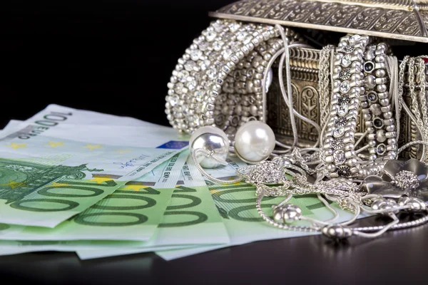 Silver jewelry and Euro — Stock Photo, Image