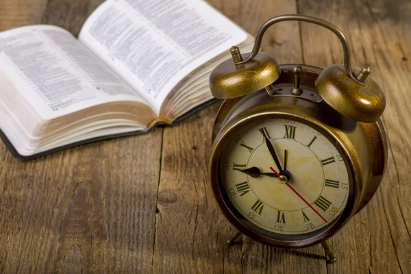 Bibel mit Uhr auf Holz — Stockfoto