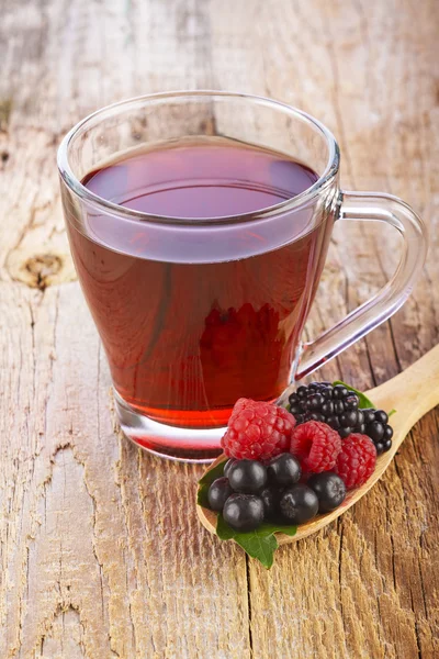 Fruit red tea with wild berries in wooden spoon — Stock Photo, Image