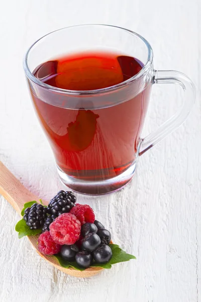 Fruit red tea with wild berries in wooden spoon — Stock Photo, Image