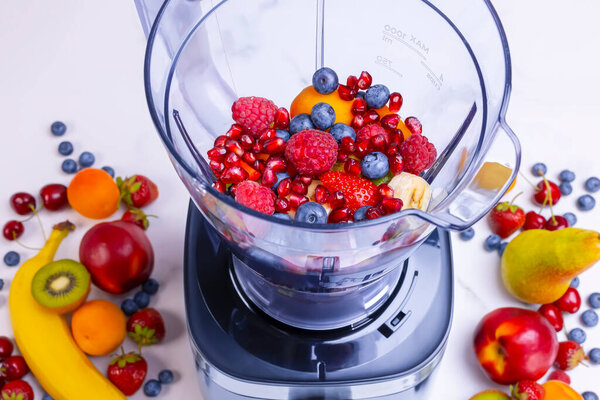 Fresh fruit smoothie in blender. Preparing a fresh drink full of vitamins for a healthy diet.