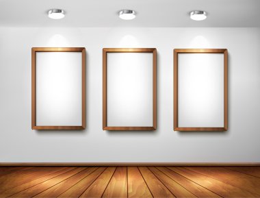 Empty wooden frames on wall with spotlights and wooden floor. Ve