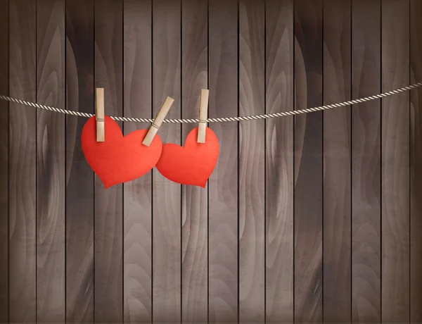 Deux cœurs suspendus à une corde devant un fond en bois. Vale — Image vectorielle