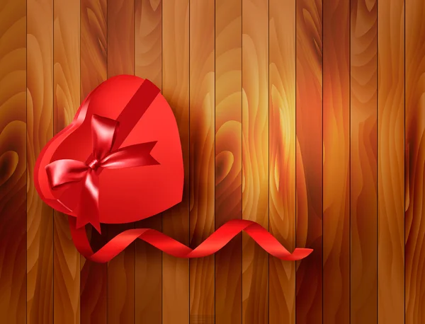 Boîte cadeau rouge en forme de coeur avec ruban sur fond en bois. Vecte — Image vectorielle