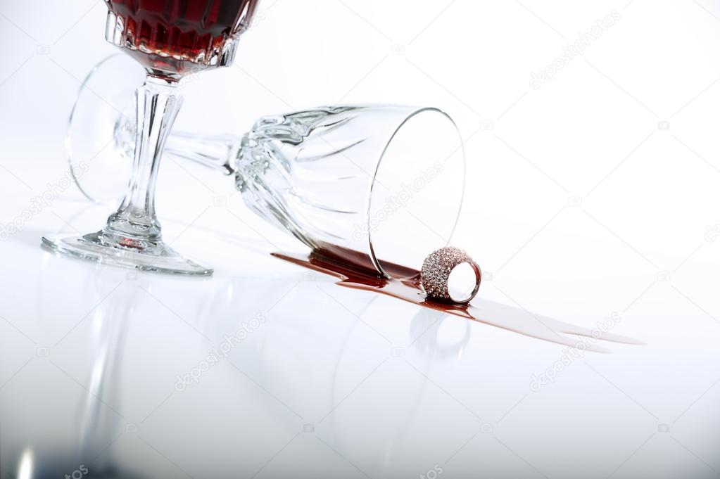 Spilled red wine from crystal wineglass