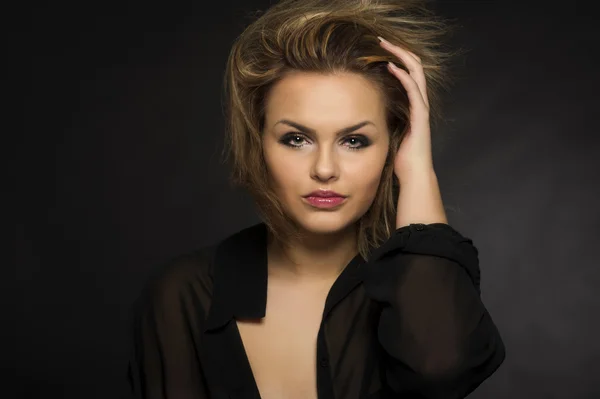 Beautiful woman with a windblown hairstyle — Stock Photo, Image