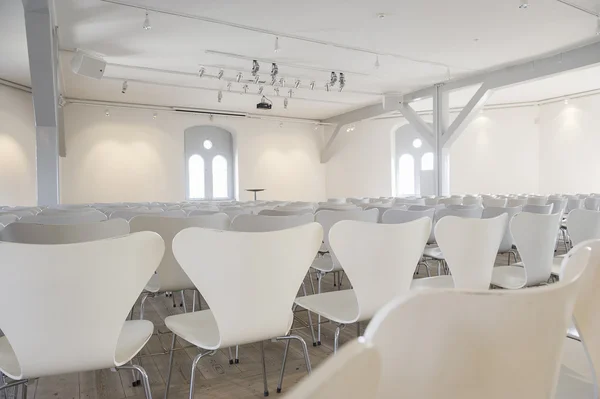 Rows of seats in a white painted room — Stock Photo, Image