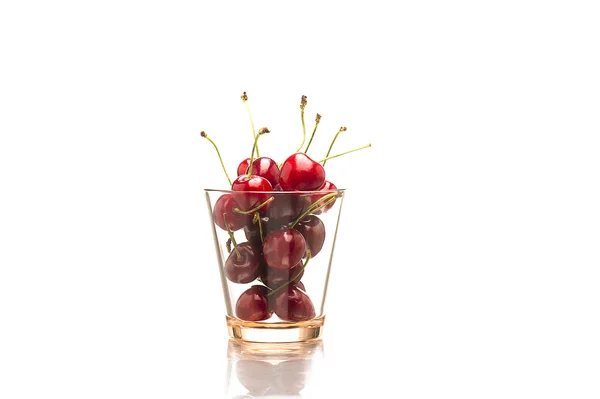 Glass full of red fresh cherries, on white — Stock Photo, Image