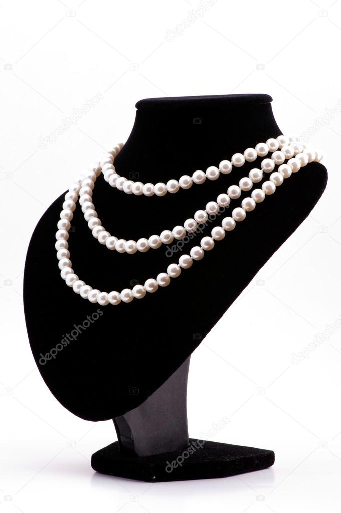 Pearl necklace on black mannequin isolated