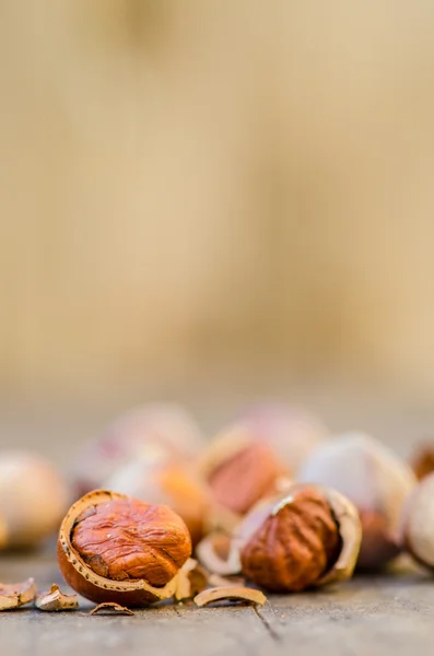 Hazelnuts on old wooden background — Stock Photo, Image
