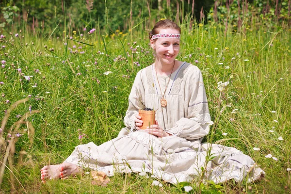 Woman sitting on a meadow — Stock Photo, Image