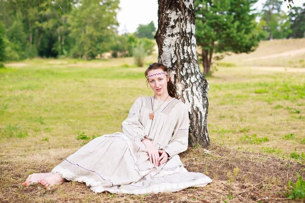 Woman sitting on a meadow — Stock Photo, Image