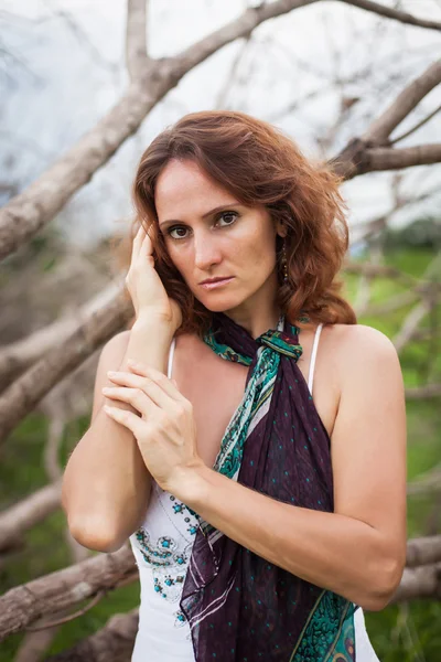 Woman on a background of dry trees — Stock Photo, Image