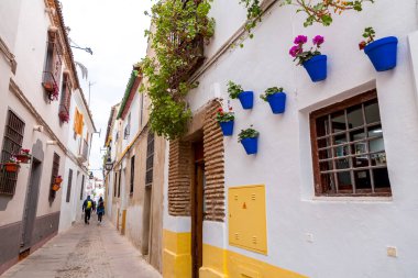 Cordoba, Spain - February 25, 2022: Street scene with traditional Andalucian architecture in the historical city of Cordoba, Spain. clipart