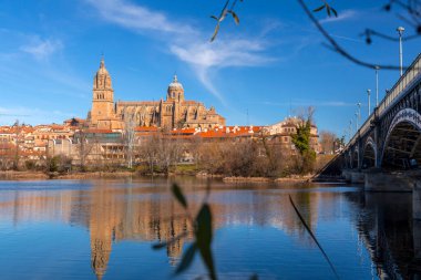 Salamanca, Spain - February 20, 2022: Salamanca skyline view with Cathedral across Tormes River, Salamanca. clipart