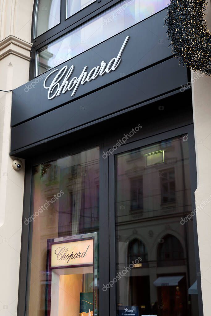Munich, Germany - December 25, 2021: Chopard brand sign and logo at the entrance of luxury stores on Maximilanstrasse, Maximilian Street in Munich, Germany.