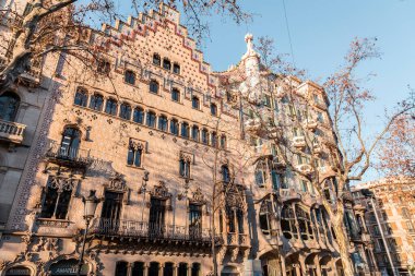 Barcelona, Spain - FEB 10, 2022: Exterior of the Casa Battlo Gaudi, museum house designed by the legendary architect Antonio Gaudi in Eixample, Barcelona, Spain. clipart