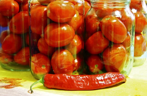 Tasty tomatoes ready to canned in glass jar — Stock Photo, Image