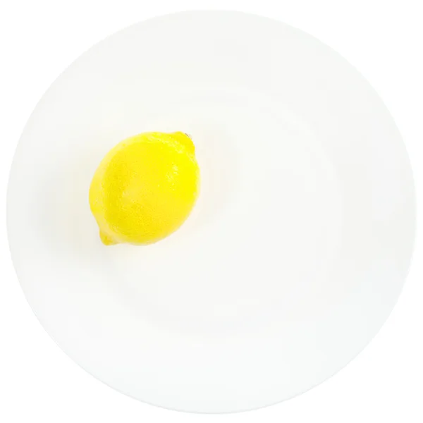 Limón amarillo brillante sobre plato blanco — Foto de Stock