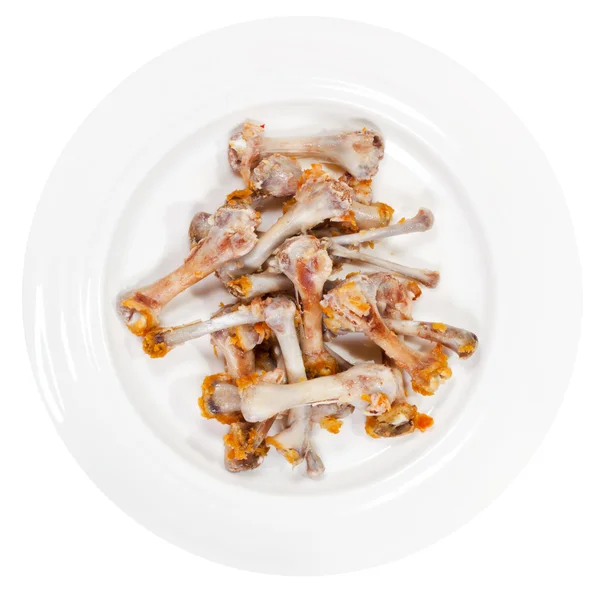 Picked chicken bones on plate — Stock Photo, Image