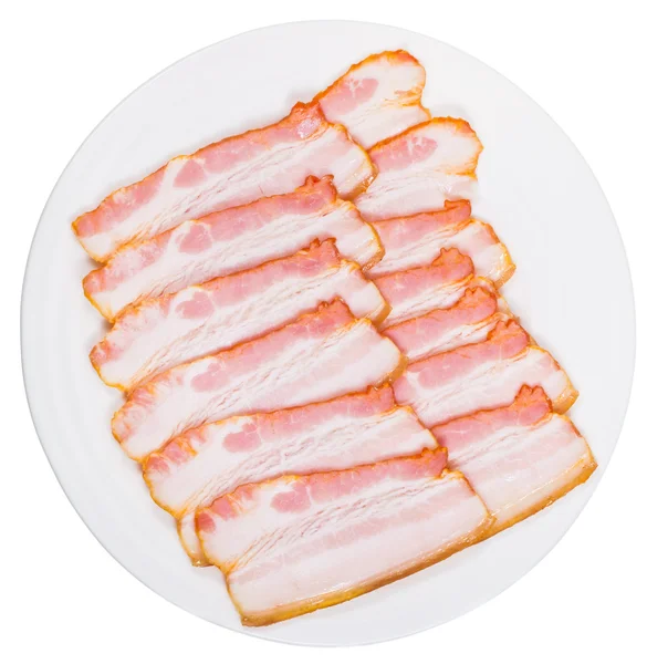 Sliced bacon on white plate — Stock Photo, Image