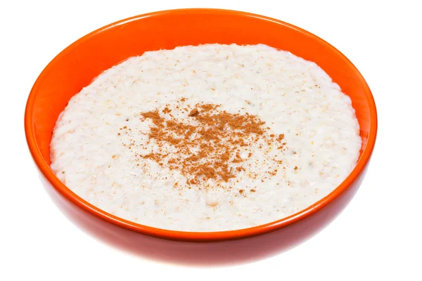 Oat porridge with cinnamon in orange bow — Stock Photo, Image