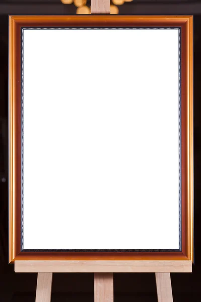 Brown wood picture frame on easel — Stock Photo, Image