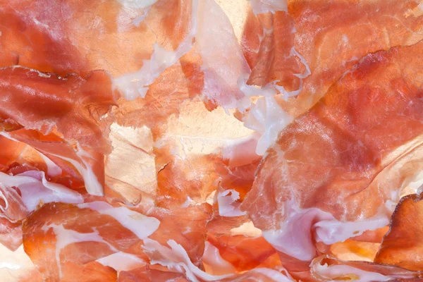 Pozadí z krájené šunky prosciutto di parma — Stock fotografie