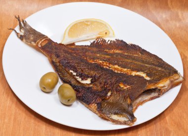 Fried sole fish on white plate