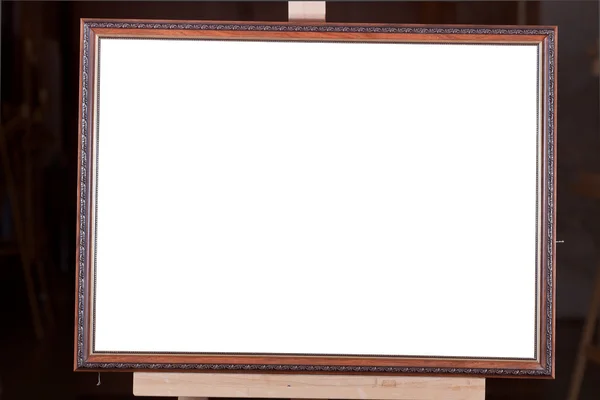 Brown wooden picture frame on easel — Stock Photo, Image