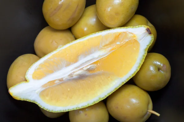Fresh lemon on green olives — Stock Photo, Image