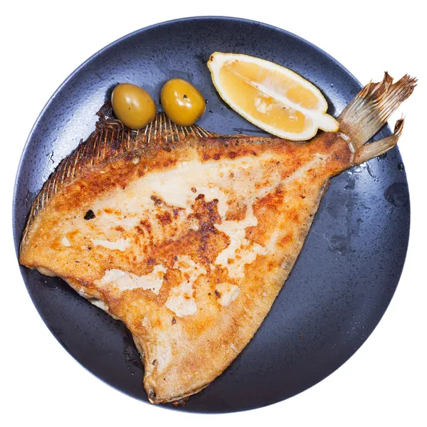 Fried sole fish on black plate — Stock Photo, Image