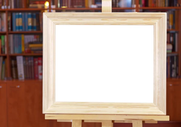 White canvas of wide wood picture frame on easel — Stock Photo, Image