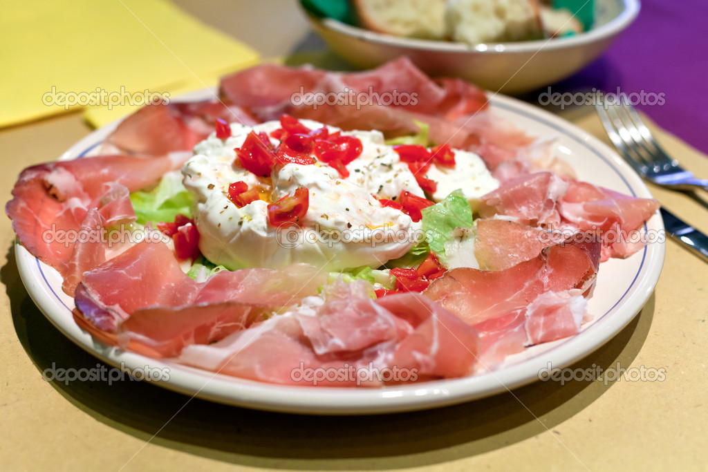 Burrata cheese with parma prosciutto crudo — Stock Photo © vvoennyy