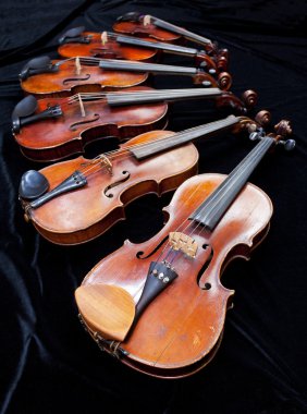 different sized fiddles on black clipart