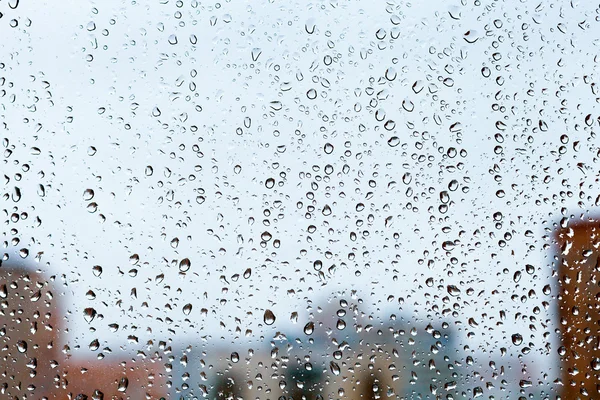 Gotas de chuva na janela de vidro em casa — Fotografia de Stock