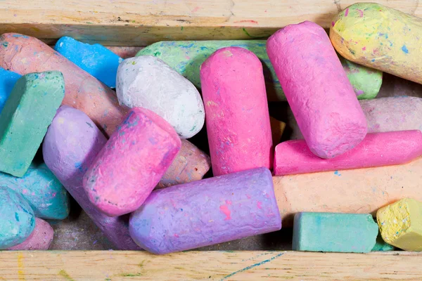 Used colored chalks in wood box — Stock Photo, Image