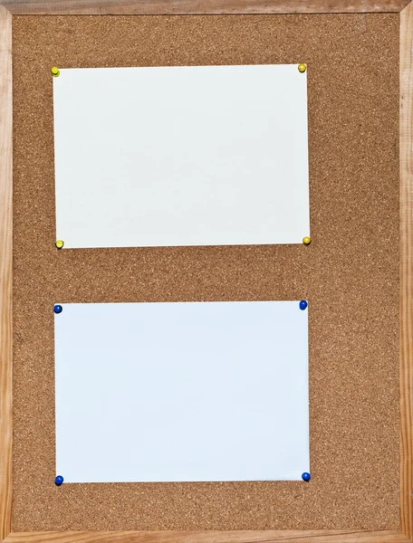 Two sheets of paper on cork board — Stock Photo, Image