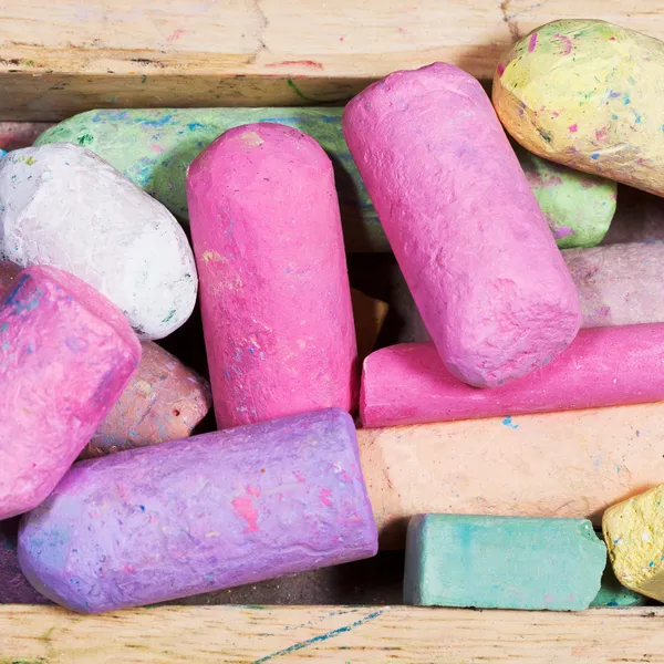 Many colored chalks in wooden box — Stock Photo, Image