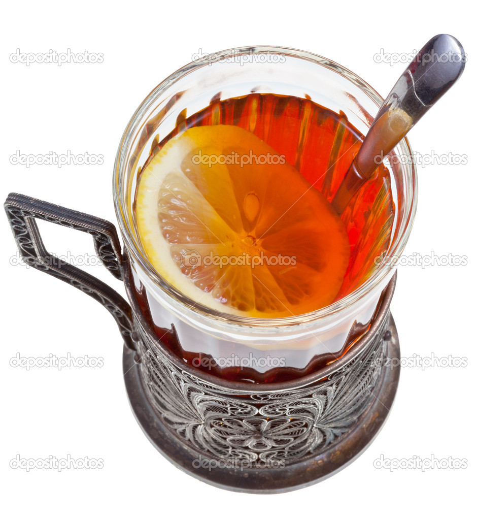 tea with lemon in vintage glass with spoon