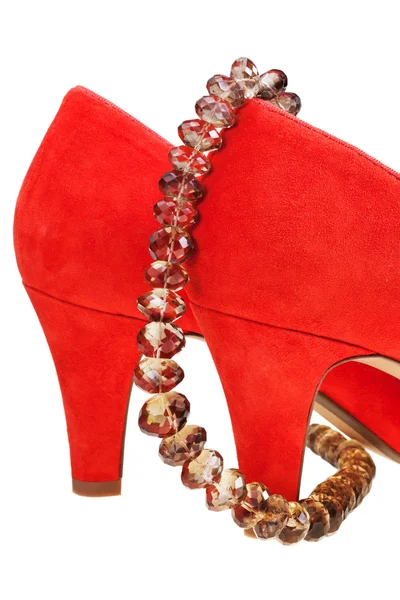 Heelpieces of red high heel pumps with necklace — Stock Photo, Image