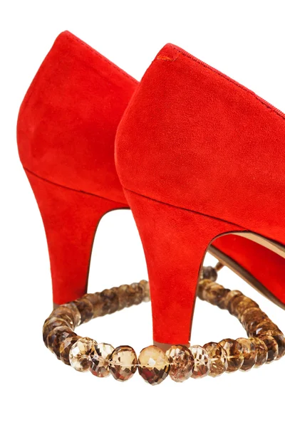 Heelpieces of red high heel pumps with necklace — Stock Photo, Image