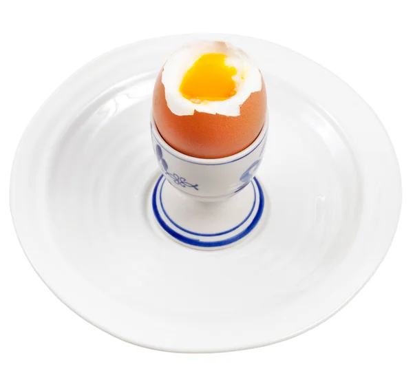 Licht gekookt ei in egg cup op witte plaat — Stockfoto